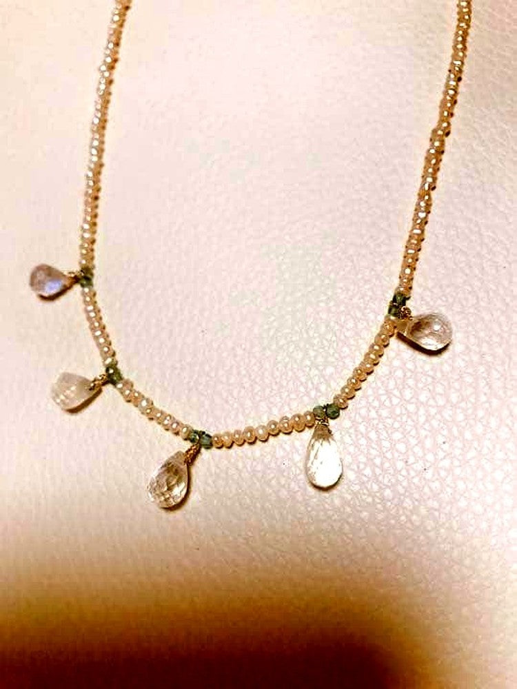 Milky Quartz necklace with aquamarine and freshwater pearl stones on a white background