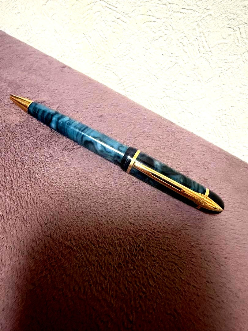 Waterman ballpoint pen in marble blue with gold trim lying horizontally on white background