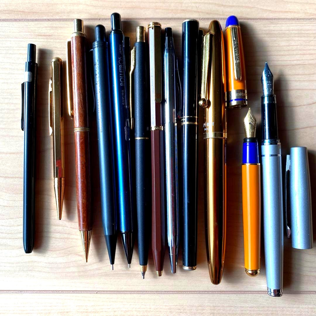 Sakura Givenchy pen set featuring 12 metal and wood fountain pens and mechanical pencils laid out
