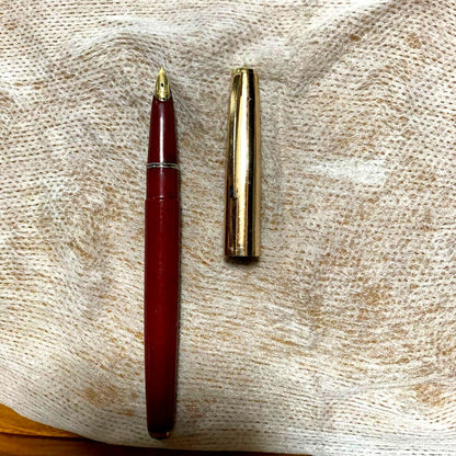 Vintage 14k PILOT SUPER100s fountain pen with gold cap and Bordeaux barrel showing inset nib