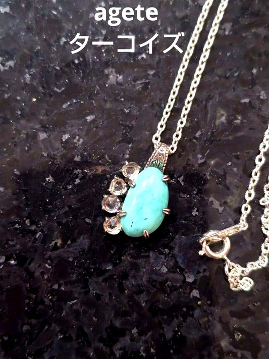 Agete silver necklace with turquoise stone and clear white topaz decorations on a delicate chain
