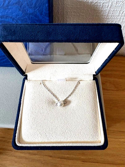 Mikimoto single pearl necklace with 6mm pearl and 40cm silver chain on white background