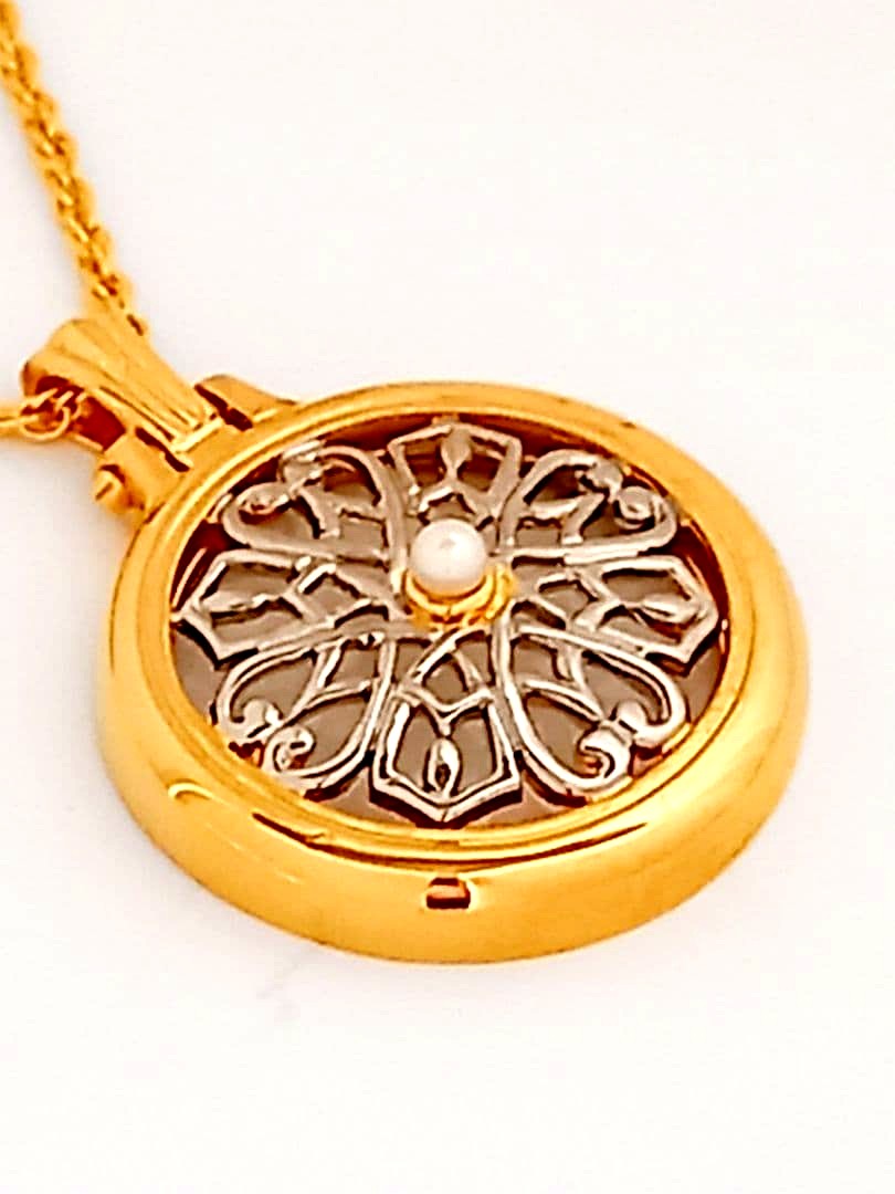 Mikimoto pendant necklace featuring a gold and silver pendant with magnifier on a 64 cm gold chain