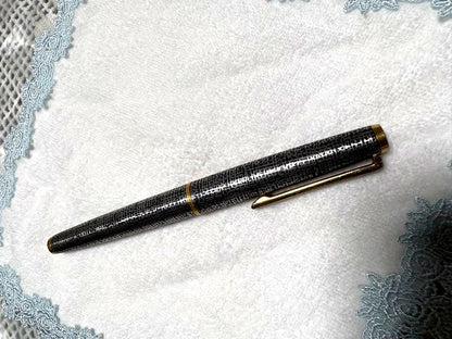 Used Pilot fountain pen with gold trim and geometric pattern, 18 karat nib, showing scratches and name engraving
