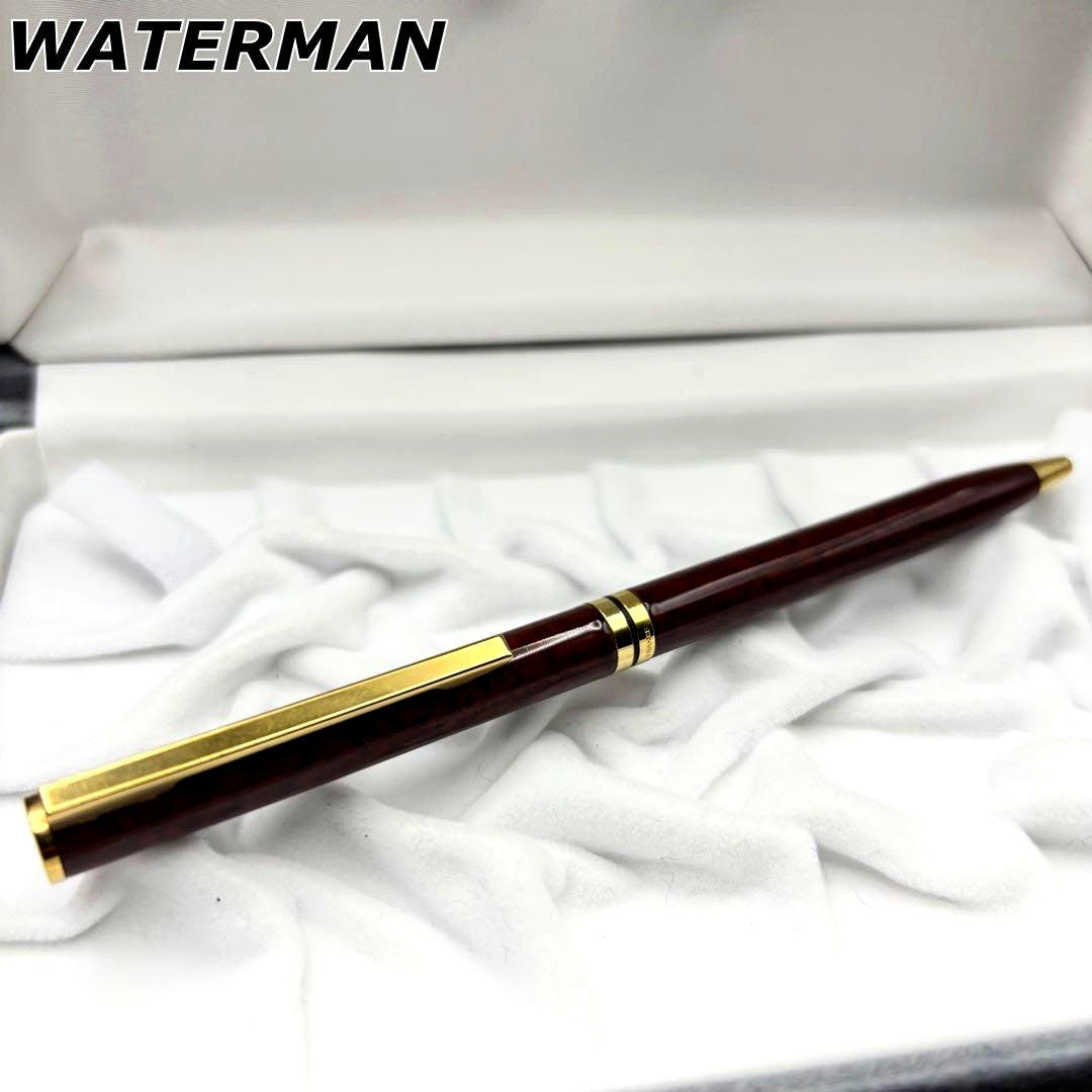 Vintage Waterman ballpoint pen with brown marble pattern and gold accents, rotary mechanism, made in France