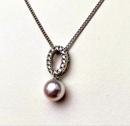 Akoya pearl pendant necklace with 7mm pearl, cubic zirconia accents, and silver 925 rhodium plated chain on white background