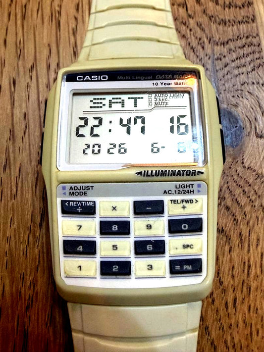 Casio Data Bank vintage watch with off-white belt showing slight discoloration and functional buttons