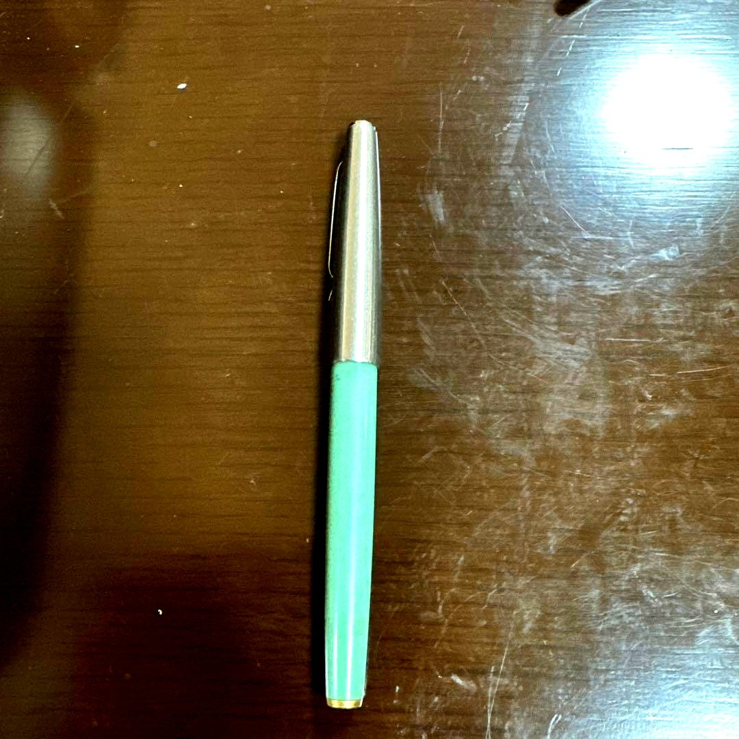 Used PILOT green fountain pen with visible scratches, discoloration, and paint peeling