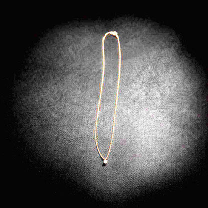 Close-up of Agate K18 18-karat gold necklace with 0.05ct diamond pendant