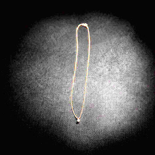 Close-up of Agate K18 18-karat gold necklace with 0.05ct diamond pendant