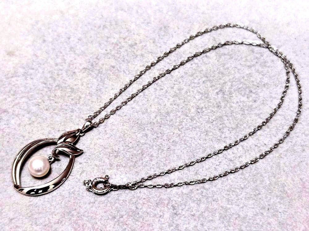 Close-up of Mikimoto 7mm pearl silver necklace with 40cm chain on a white background