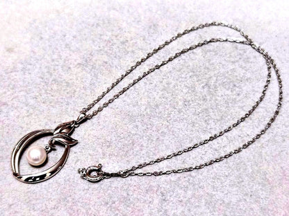 Close-up of Mikimoto 7mm pearl silver necklace with 40cm chain on a white background