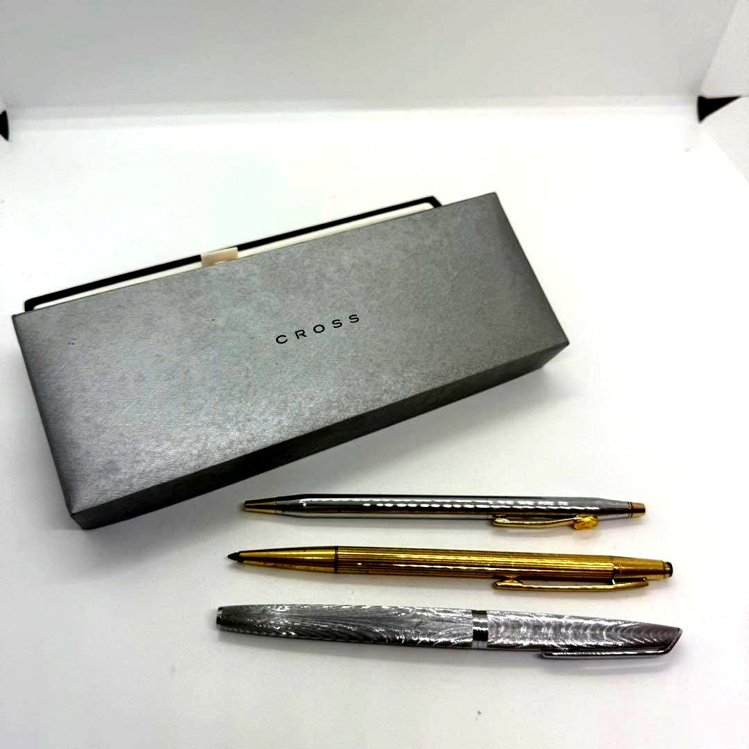 Cross pen set with three used pens including ballpoint and fountain pens showing minor wear and scratches
