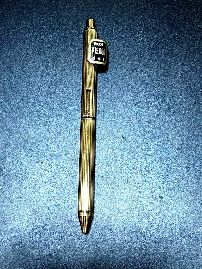 PILOT Mechanical Pencil Ballpoint Pen in gold color lying on a white background