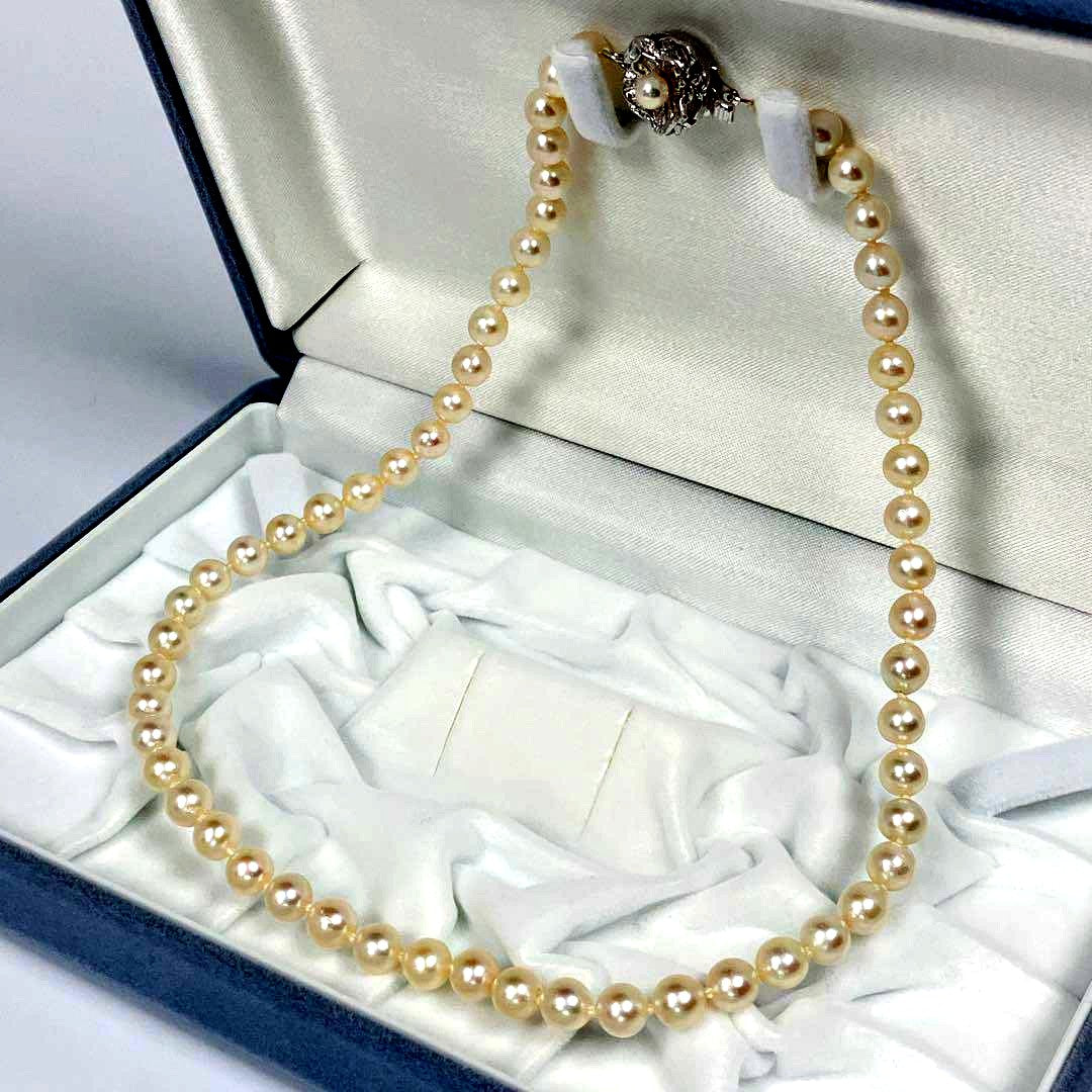 Akoya pearl necklace with 5.8 to 6.3mm pearls and silver clasp on a white background