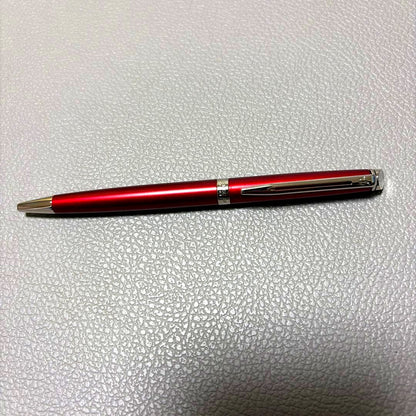 Red Waterman ballpoint pen stored in a pen case with sleek design