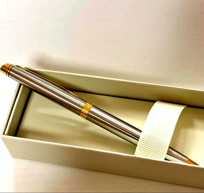 Waterman ballpoint pen with silver body and gold trim on a white background