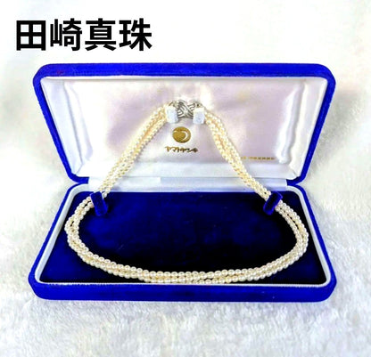 Tazaki Pearl 3-Strand necklace with baby freshwater pearls and silver case on white background