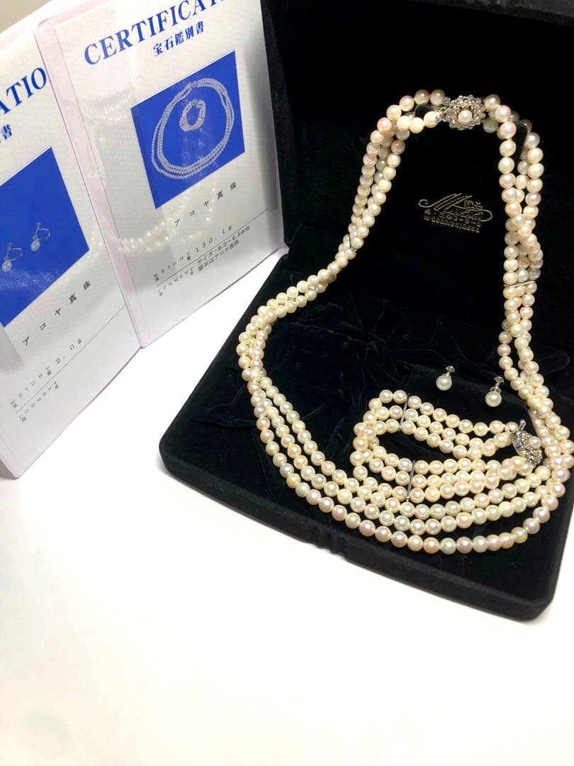 Akoya pearl silver necklace, bracelet, and earrings set with white pearls and sterling silver accents