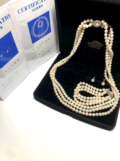 Akoya pearl silver necklace, bracelet, and earrings set with white pearls and sterling silver accents