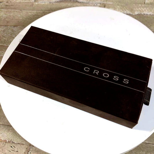 CROSS black ballpoint pen with company logo, displayed alongside its protective case and bookmark
