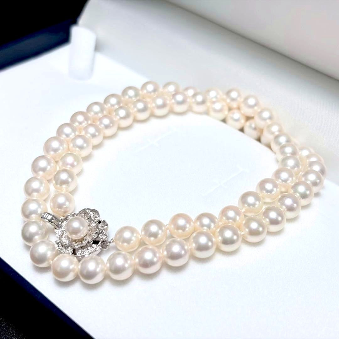 Akoya pearl necklace with white 6.5-6.9mm pearls and silver clasp on a white background
