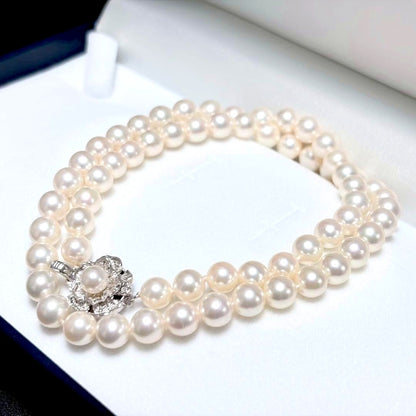 Akoya pearl necklace with white 6.5-6.9mm pearls and silver clasp on a white background