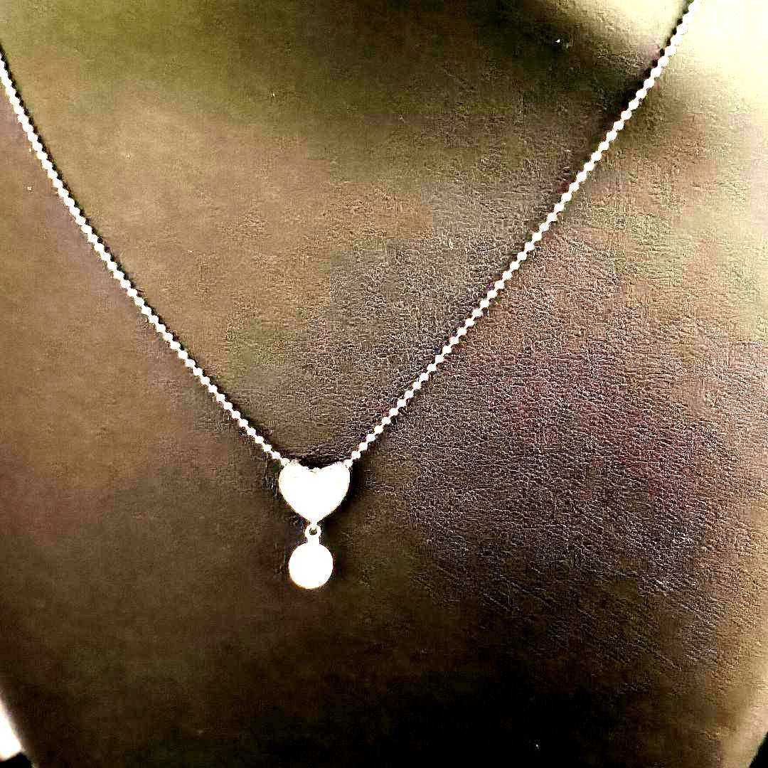 Tasaki necklace featuring a small pearl heart pendant on a 40 cm sterling silver chain