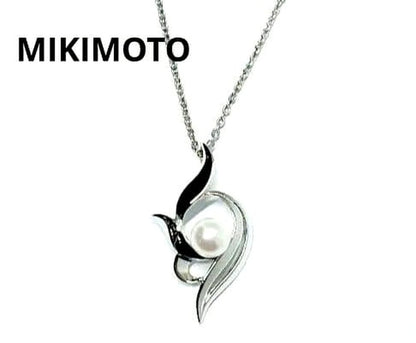Mikimoto silver necklace with 5.9mm pearl, Nina Ricci heart motif necklace, Tocca blue handkerchief accessory and Snow Skin design
