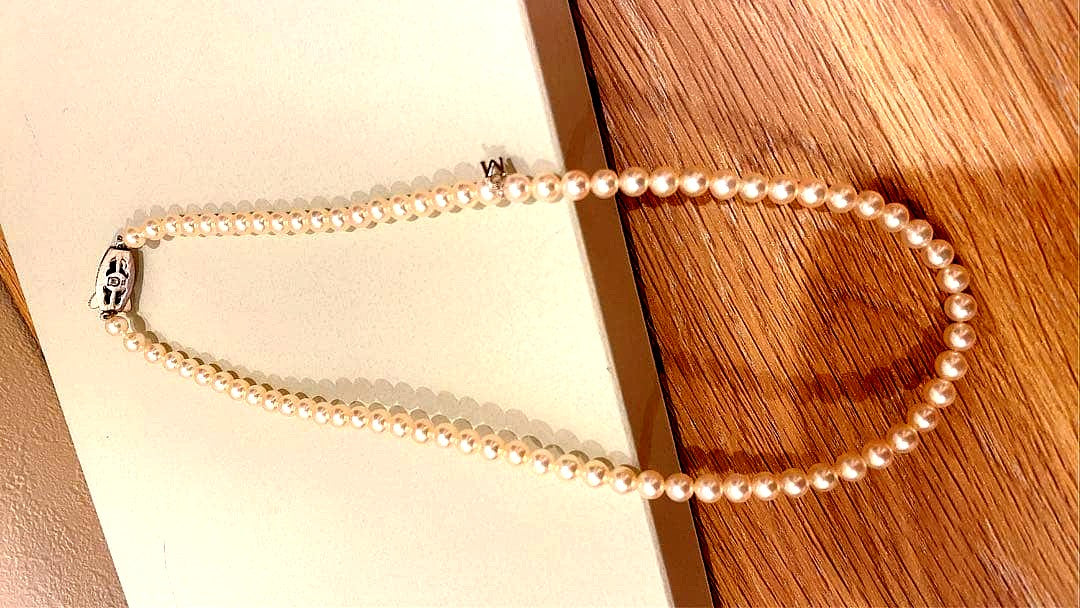 Mikimoto Akoya pearl necklace 43cm with 6.0−6.5mm pearls and silver clasp on white background