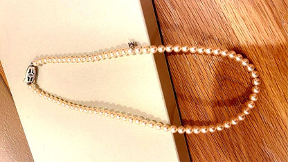 Mikimoto Akoya pearl necklace 43cm with 6.0−6.5mm pearls and silver clasp on white background