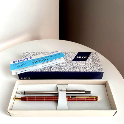 Pilot Pen mechanical pencil and ballpoint pen set with red pen and mechanical pencil showing signs of wear and dirt