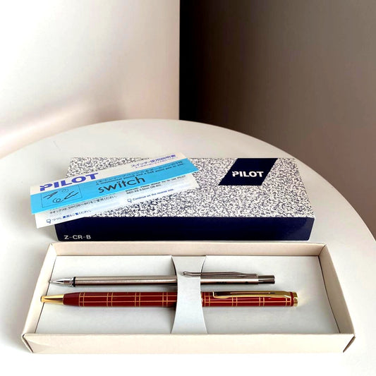Pilot Pen mechanical pencil and ballpoint pen set with red pen and mechanical pencil showing signs of wear and dirt
