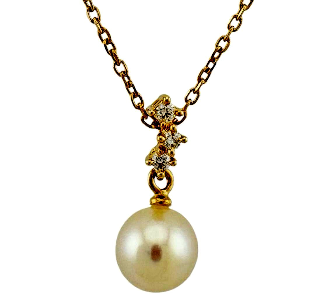 TASAKI Akoya pearl necklace with diamond accents in 18K gold on a white background