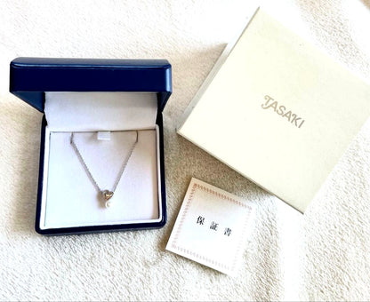 Used Tasaki pearl necklace with original box showing peeling and fading at bottom