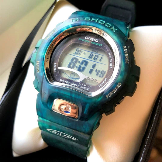 Casio G-Shock digital watch with transparent blue resin band and digital display showing time