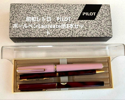 Set of 4 vintage PILOT Laureate ballpoint pens in pink, Bordeaux, and Bordeaux marble colors with visible aging