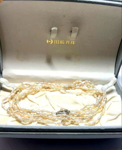 Tasaki genuine pearl necklace 66 cm length elegant round pearls on white background