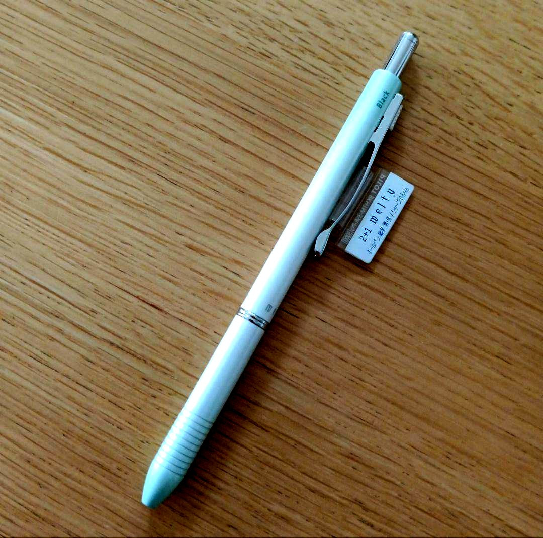Pilot Melty 2+1 multi-function swing-type pen with black and red ballpoint tips and green 0.5mm mechanical pencil barrel
