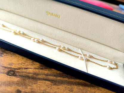Tasaki K18 gold station necklace with white pearls on a 39 cm chain displayed on a white background