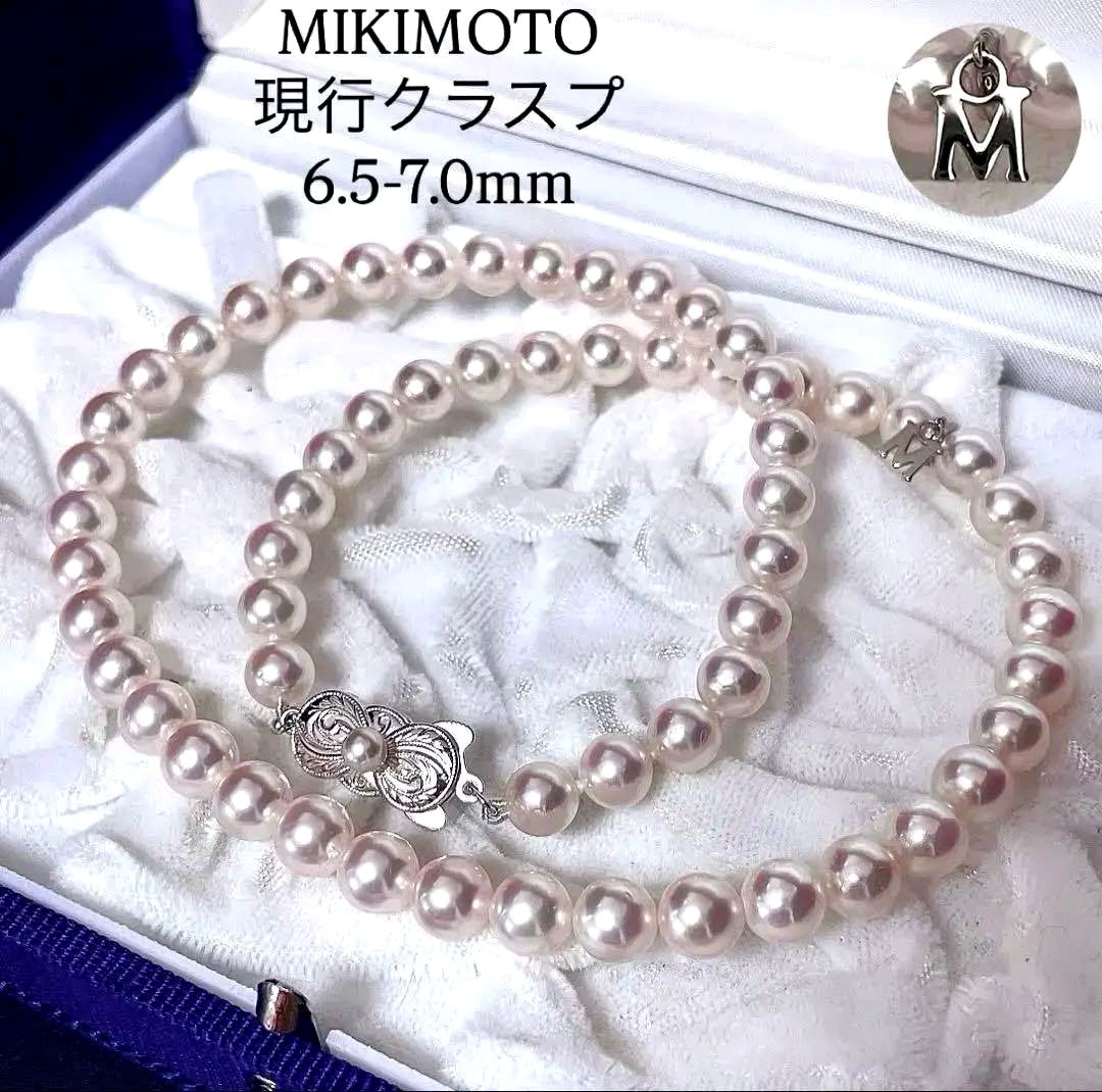 Mikimoto Akoya pearl necklace with 6.5-7mm white pink pearls, M charm, and silver current clasp on a white background