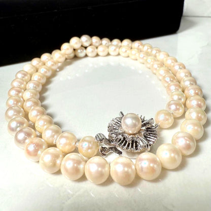 Okoya pearl necklace with pink pearls and silver clasp on white background
