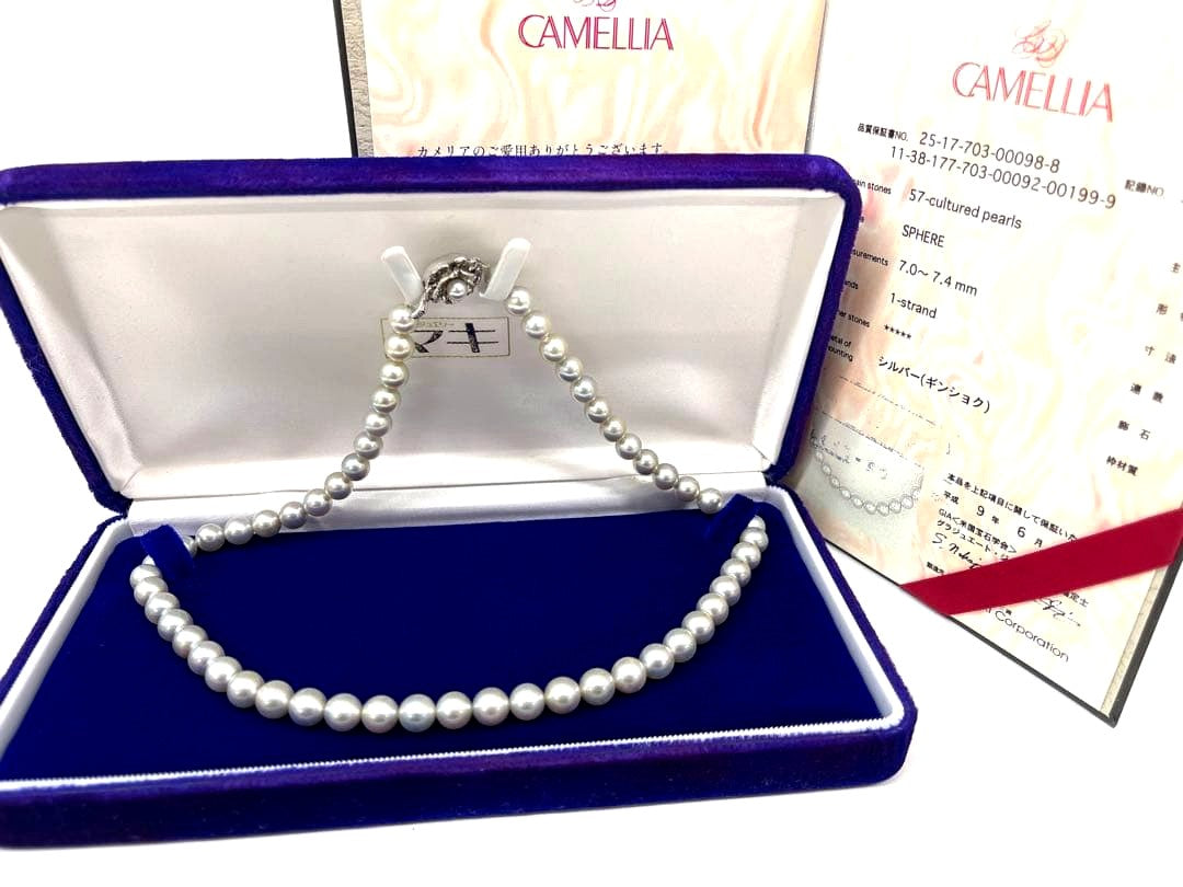 Camellia Akoya pearl necklace with 7.0-7.4mm pearls, single strand, and silver clasp on white background