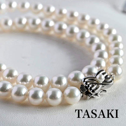 Takatsuki Akoya pearl necklace with 7.5mm round pearls and silver ribbon clasp on a white background