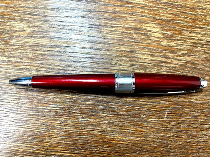 Cross Apogée ballpoint pen in vivid wine red with visible scratches on the body, Japan import