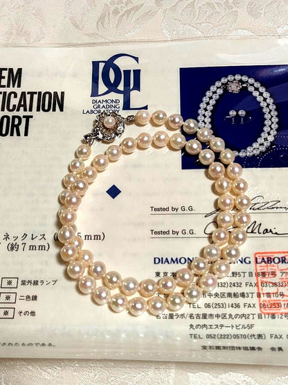 Akoya pearl necklace with white pearls 6.5-6.9 mm and silver push-insertion clasp on white background