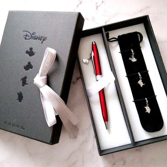 Red Cross Disney Limited Sentiment rotating ballpoint pen with 4 charms and black carrying case