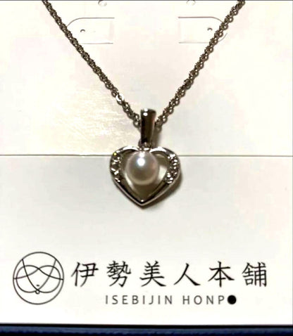 Heart-shaped silver necklace with white Akoya pearls on a white background