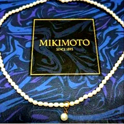 MIKIMOTO K18 pearl necklace with 5mm pearls and updated replacement thread, shown on white background