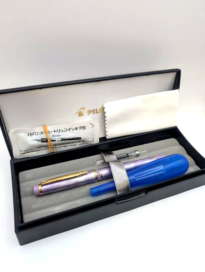 Pilot Marble Purple 14K fountain pen with metal and resin body, shown with case and cleaning cloth